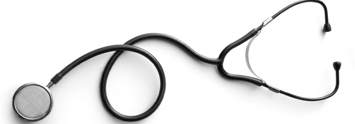 Black stethoscope placed on a white surface